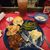 This image shows a partially eaten meal consisting of barbecue brisket, mashed potatoes, green beans, a biscuit, and gravy, accompanied by a bread roll and iced tea, with a bottle of ketchup on the side, on a table with a red cloth.