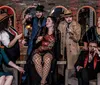 The image features a group of people dressed in 1920s-style attire enjoying a dinner show with text reviews praising the performance and service alongside an inset of rolled pasta with sauce