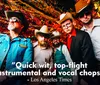 A group of five men sporting cowboy hats and eclectic outfits pose confidently with a festive colorful tinsel background accompanied by a quote praising their wit and musical talent attributed to the Los Angeles Times