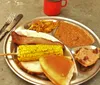 The image is a collage of four different photos themed around a traditional Western or cowboy lifestyle featuring musicians in cowboy attire a person smoking meat old-fashioned kitchen items and a plate of hearty food typically found in American Western cuisine