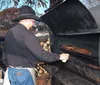 The image is a collage of four different photos themed around a traditional Western or cowboy lifestyle featuring musicians in cowboy attire a person smoking meat old-fashioned kitchen items and a plate of hearty food typically found in American Western cuisine