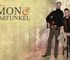 The image features two men posing with a guitar against the backdrop of an autumnal forest with text overlay that reads The Sound of SIMON  GARFUNKEL