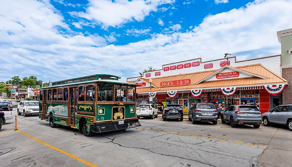 A trolley-style tour bus drives past a nostalgic American five-and-dime store adorned with patriotic bunting in a bustling street scene