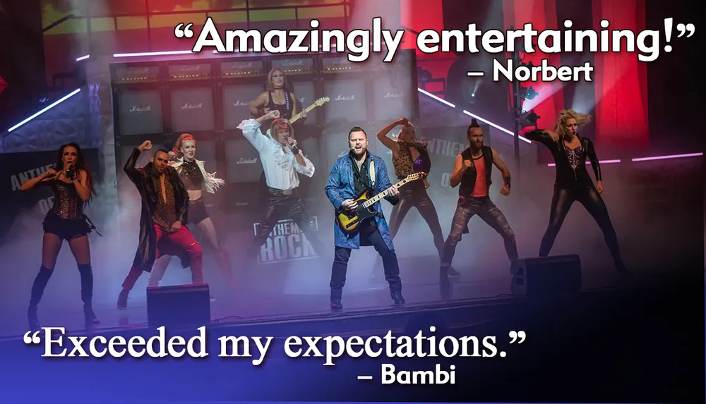 The image captures a dynamic stage performance with dancers and a guitarist accompanied by glowing reviews from Norbert and Bambi