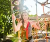 A group of people is enjoying a high ropes adventure course on a sunny day